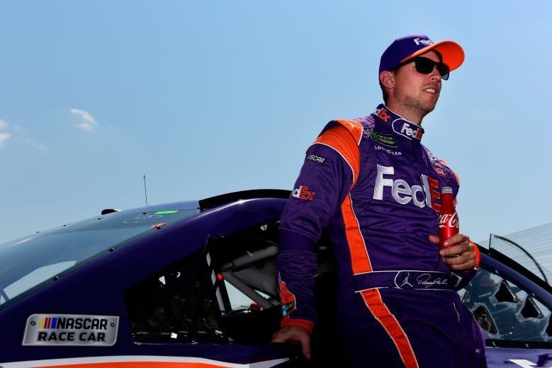 WATKINS GLEN, NY - AUGUST 05: Denny Hamlin, driver of the #11 FedEx Ground Toyota, stands on the grid prior to the start of the Monster Energy NASCAR Cup Series GoBowling at The Glen at Watkins Glen International on August 5, 2018 in Watkins Glen, New York. (Photo by Jared C. Tilton/Getty Images) | Getty Images