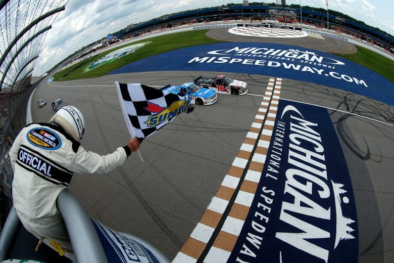 BROOKLYN, MI - AUGUST 11:  Brett Moffitt, driver of the #16 Hino Toyota, takes the checkered flag in front of Johnny Sauter, driver of the #21 ISM Connect Chevrolet, to win the NASCAR Camping World Truck Series Corrigan Oil 200 at Michigan International Speedway on August 11, 2018 in Brooklyn, Michigan.  (Photo by Sean Gardner/Getty Images) | Getty Images