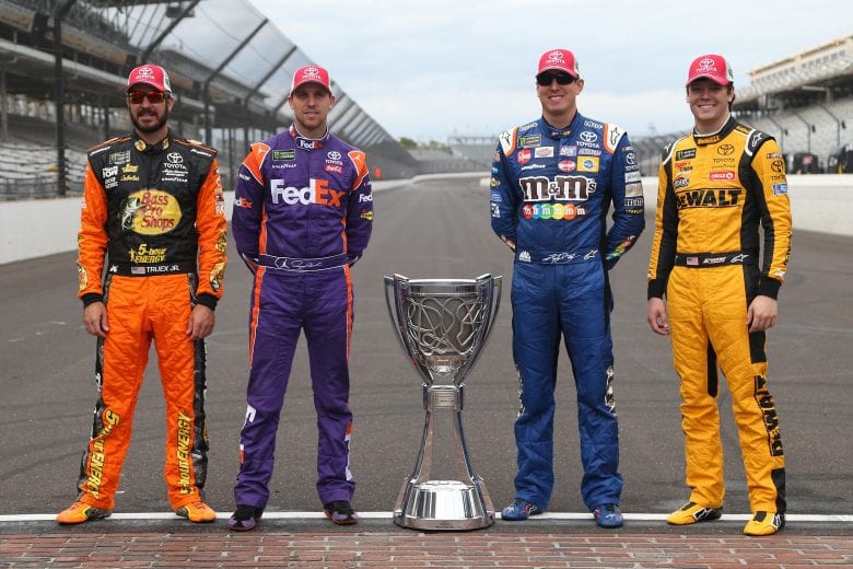 INDIANAPOLIS, IN - SEPTEMBER 10: Martin Truex Jr., driver of the #78 Auto-Owners Insurance Toyota, Denny Hamlin, driver of the #11 FedEx Possibilities Toyota, Kyle Busch, driver of the #18 M&M's Caramel Toyota, Erik Jones, driver of the #20 buyatoyota.com Toyota, pose for a photo with the Monster Energy NASCAR Cup Series trophy after making the playoffs following the Monster Energy NASCAR Cup Series Big Machine Vodka 400 at the Brickyard at Indianapolis Motor Speedway on September 10, 2018 in Indianapolis, Indiana. (Photo by Brian Lawdermilk/Getty Images) | Getty Images