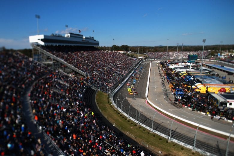 MARTINSVILLE, VA - OCTOBER 28: (Editor's Note: This image was created using a tilt-shift lens.) Joey Logano, driver of the #22 Shell Pennzoil Ford, and Kyle Busch, driver of the #18 M&M's Halloween Toyota, lead the field into turn one during the Monster Energy NASCAR Cup Series First Data 500 at Martinsville Speedway on October 28, 2018 in Martinsville, Virginia. (Photo by Sean Gardner/Getty Images) | Getty Images