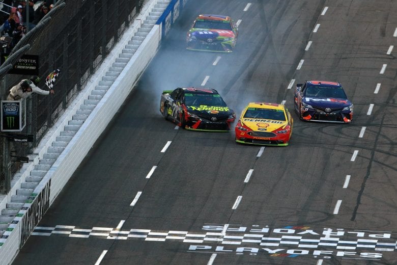 Joey Logano pulls away to the checkered flag after contact with Martin Truex Jr.