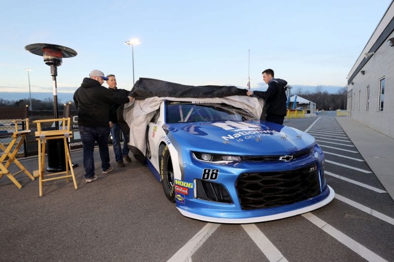 MOORESVILLE, NC - DECEMBER 06: Alex Bowman pulls the tarp off the #88 car during the Nationwide 2019 Paint Scheme Reveal at GoPro Motorplex on December 6, 2018 in Mooresville, North Carolina. (Photo by Streeter Lecka/Getty Images) | Getty Images