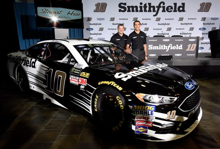 KANNAPOLIS, NC - NOVEMBER 08:  Aric Almirola (R) and Tony Stewart, co-owner of Stewart-Haas Racing, pose for a photo opportunity with the #10 Smithfield Ford during a press conference at Stewart-Haas Racing on November 8, 2017 in Kannapolis, North Carolina. Stewart-Haas Racing introduced Almirola as their driver of the #10 Smithfield Ford for the 2018 season.  (Photo by Jared C. Tilton/Stewart-Haas Racing via Getty Images) | Getty Images