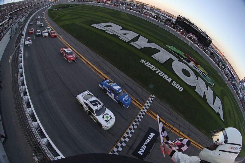 DAYTONA BEACH, FL - FEBRUARY 17:  Tyler Reddick, driver of the #9 BurgerFi Chevrolet, takes the checkered flag in front of Elliott Sadler, driver of the #1 OneMain Financial Chevrolet, to win the NASCAR Xfinity Series PowerShares QQQ 300 at Daytona International Speedway on February 17, 2018 in Daytona Beach, Florida.  (Photo by Sean Gardner/Getty Images) | Getty Images