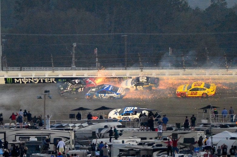 Joey Logano's No. 22 Ford threads its way through a multicar crash in the season-opening Daytona 500 in 2018.