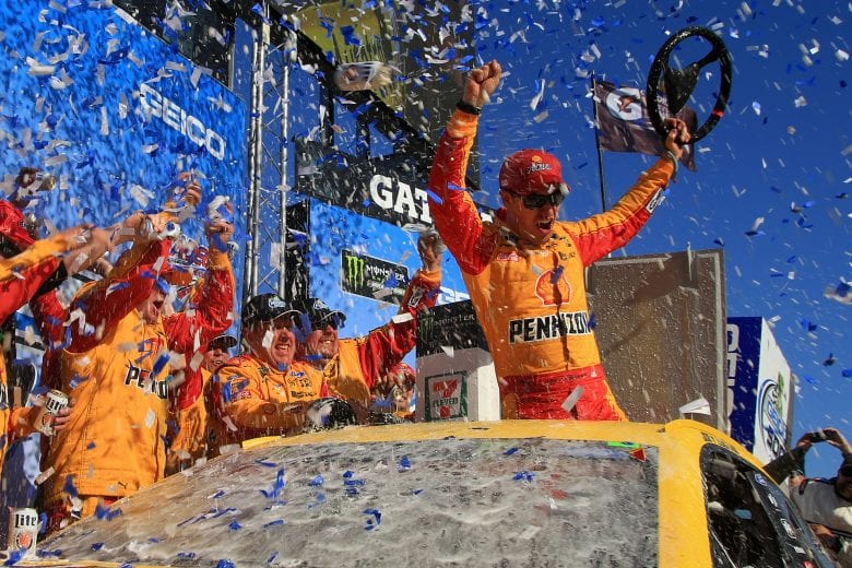 Joey Logano and his crew cheer in Victory Lane at Talladega Superspeedway.