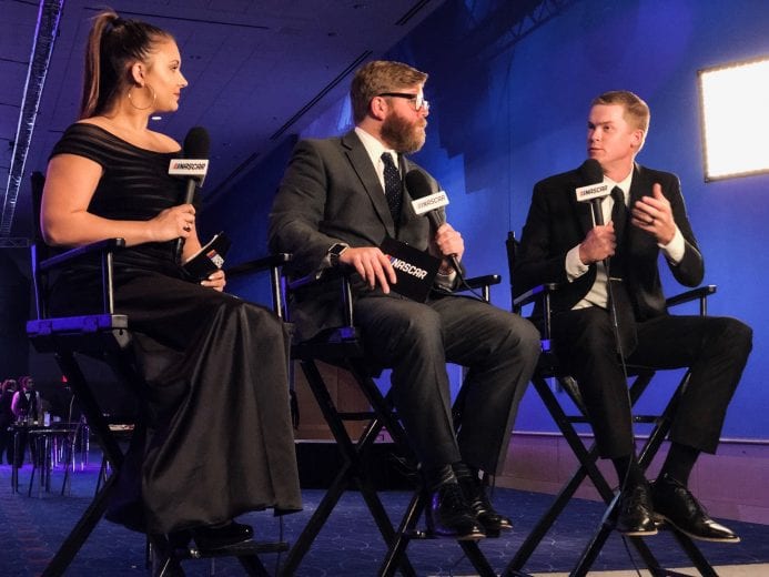 Derek Thorn speaks with Jessie Punch and Chuck Busch at the NASCAR Awards in Charlotte.
