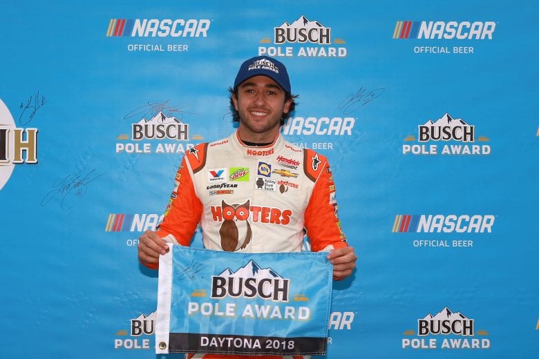 Chase Elliott holds up the Busch Pole Award flag.