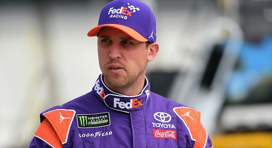 Denny Hamlin looks on while walking through the garage at Atlanta Motor Speedway.