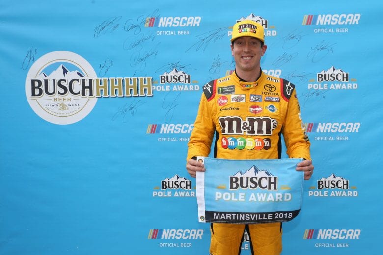 Kyle Busch holds up the Busch Pole Award flag.