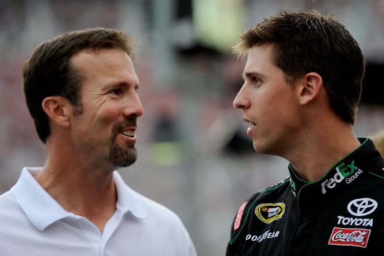 BRISTOL, TN - AUGUST 21: Denny Hamlin (R), driver of the #11 FedEx Ground Toyota, talks with team owner J.D. Gibbs prior to the start of the NASCAR Sprint Cup Series IRWIN Tools Night Race at Bristol Motor Speedway on August 21, 2010 in Bristol, Tennessee. (Photo by John Harrelson/Getty Images for NASCAR) | Getty Images
