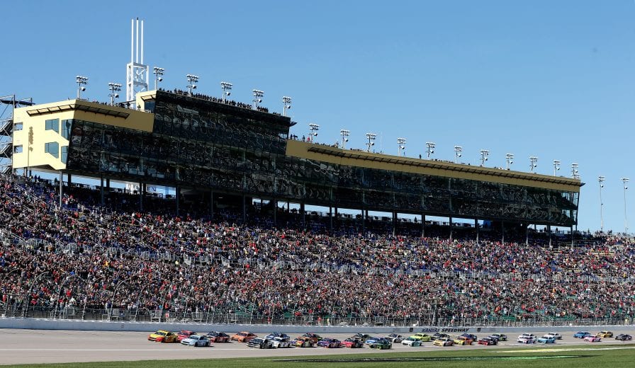 KANSAS CITY, KS - OCTOBER 21:  Joey Logano, driver of the #22 Shell Pennzoil Ford, and Kevin Harvick, driver of the #4 Busch Light Ford, lead the field at the start of the Monster Energy NASCAR Cup Series Hollywood Casino 400 at Kansas Speedway on October 21, 2018 in Kansas City, Kansas.  (Photo by Brian Lawdermilk/Getty Images) | Getty Images