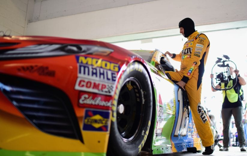 HOMESTEAD, FL - NOVEMBER 17:  Kyle Busch, driver of the #18 M&M's Toyota, climbs into his car in the garage area during practice for the Monster Energy NASCAR Cup Series Ford EcoBoost 400 at Homestead-Miami Speedway on November 17, 2018 in Homestead, Florida.  (Photo by Jared C. Tilton/Getty Images) | Getty Images