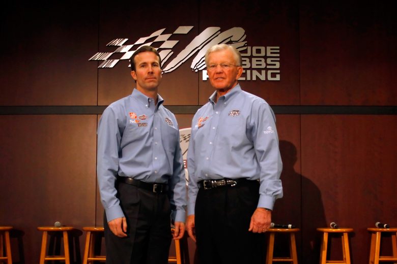 HUNTERSVILLE, NC - JANUARY 27: Joe Gibbs (R) poses with JGR President J.D. Gibbs (L) during the NASCAR Sprint Media Tour hosted by Charlotte Motor Speedway, held at Joe Gibbs Racing, on January 27, 2011 in Huntersville, North Carolina. (Photo by Jason Smith/Getty Images for NASCAR) | Getty Images