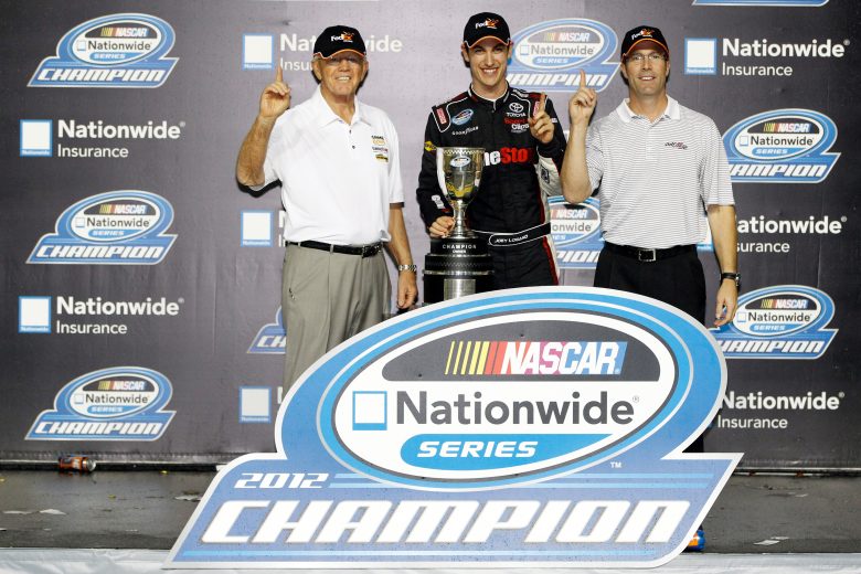 HOMESTEAD, FL - NOVEMBER 17: Team owner Joe Gibbs, Joey Logano, driver of the #18 GameStop/Afterglow Toyota, and J.D. Gibbs celebrate after winning the owners point championship after the NASCAR Nationwide Series Ford EcoBoost 300 at Homestead-Miami Speedway on November 17, 2012 in Homestead, Florida. (Photo by Tom Pennington/Getty Images) | Getty Images