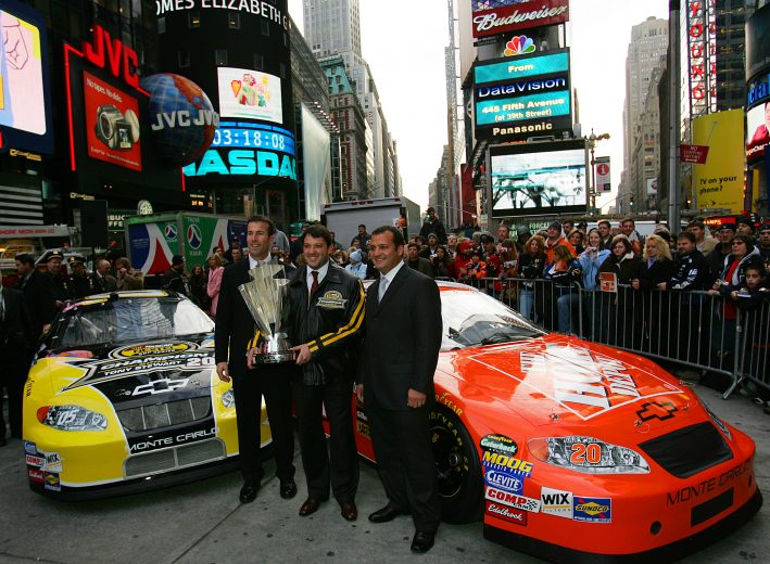 NEW YORK - DECEMBER 1: Tony Stewart (C), the 2005 NASCAR Nextel Cup champion, poses with team owner JD Gibbs (L) and crew chief Greg Zipadelli with the Nextel Cup in Times Square December 1, 2004 in New York City. (Photo by Chris Trotman/Getty Images) | Getty Images