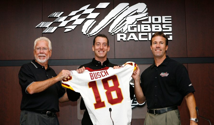 HUNTERSVILLE, NC - AUGUST 14: (L-R) Interstate Batteries Chairman Norm Miller, NEXTEL Cup Series driver Kyle Busch and Joe Gibbs Racing team president J.D. Gibbs announce that Busch will join Joe Gibbs Racing next season during a press conference on August 14, 2007 in Huntersville, North Carolina. (Photo by Kevin C. Cox/Getty Images) | Getty Images