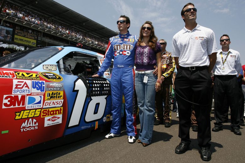 INDIANAPOLIS, IN - JULY 27: (L-R) Kyle Busch, driver of the #18 M&M's Toyota, stands with Samantha Sarcinella and J.D. Gibbs, President of Joe Gibbs Racing, during pre-race activities for the NASCAR Sprint Cup Series Allstate 400 at the Brickyard at Indianapolis Motor Speedway on July 27, 2008 in Indianapolis, Indiana. (Photo by Jason Smith/Getty Images for NASCAR) | Getty Images