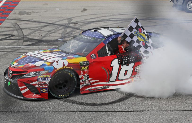 JOLIET, IL - JULY 01:  Kyle Busch, driver of the #18 Skittles Red White & Blue Toyota, celebrates with a burnout after winning the Monster Energy NASCAR Cup Series Overton's 400 at Chicagoland Speedway on July 1, 2018 in Joliet, Illinois.  (Photo by Jonathan Daniel/Getty Images) | Getty Images
