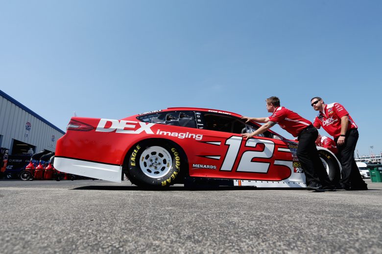 SPARTA, KY - JULY 13:  Crew members push the car of Ryan Blaney, driver of the #12 DEX Imaging Ford, through the garage area during practice for the Monster Energy NASCAR Cup Series Quaker State 400 presented by Walmart at Kentucky Speedway on July 13, 2018 in Sparta, Kentucky.  (Photo by Brian Lawdermilk/Getty Images) | Getty Images