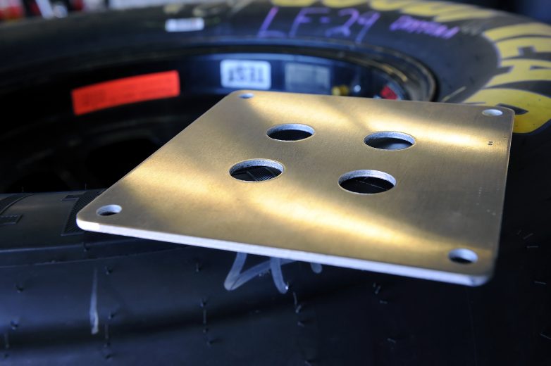 DAYTONA BEACH, FL - JANUARY 22: The 29/32'' restrictor plate sits atop a set of Goodyear tires in the garage during testing at Daytona International Speedway on January 22, 2011 in Daytona Beach, Florida. (Photo by Jared C. Tilton/Getty Images for NASCAR) | Getty Images