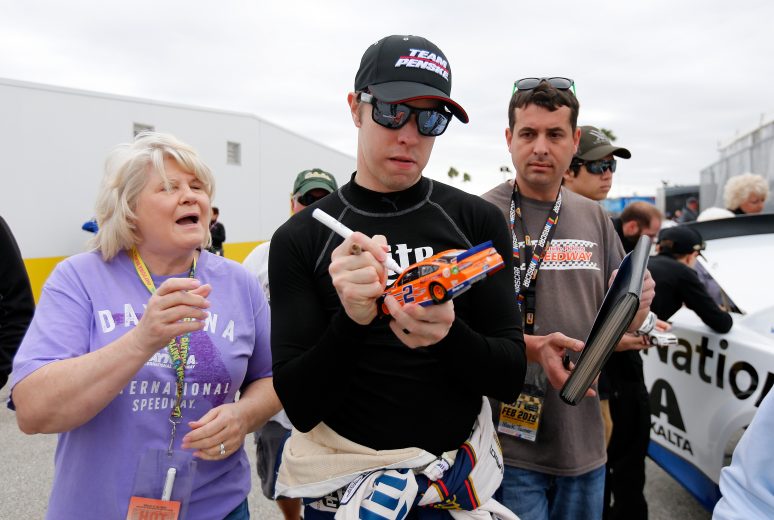 Brad Keselowski signs autographs at Daytona.