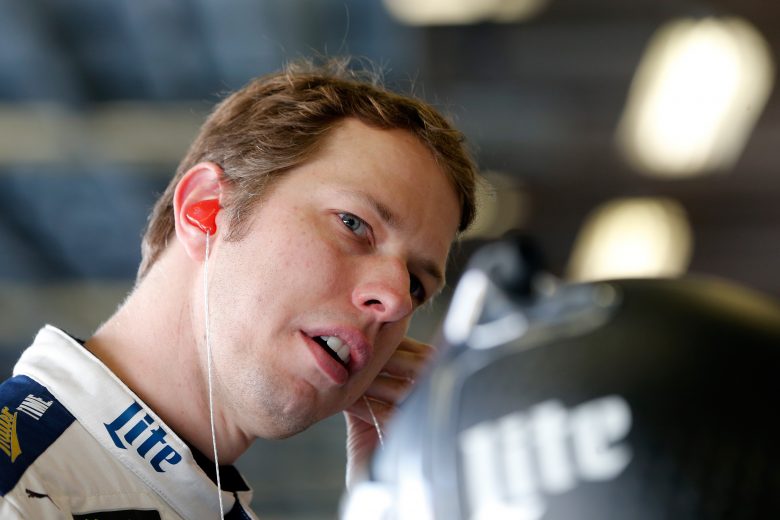 Brad Keselowski looks on in the garage at Daytona.