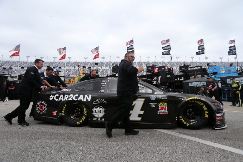 The No. 4 car of Kevin Harvick is pushed through the garage.