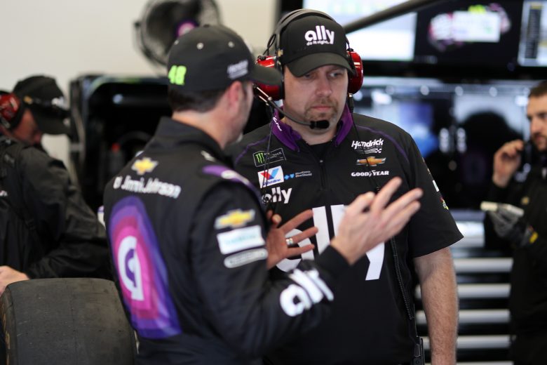 Jimmie Johnson and crew chief Kevin Meendering talk in the garage during practice
