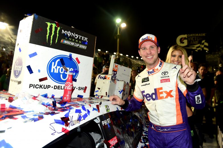DAYTONA BEACH, FL - FEBRUARY 17: Denny Hamlin, driver of the #11 FedEx Express Toyota, celebrates in Victory Lane by placing the Winner's Sticker on his car in the Monster Energy NASCAR Cup Series 61st Annual Daytona 500 at Daytona International Speedway on February 17, 2019 in Daytona Beach, Florida. (Photo by Jared C. Tilton/Getty Images) | Getty Images