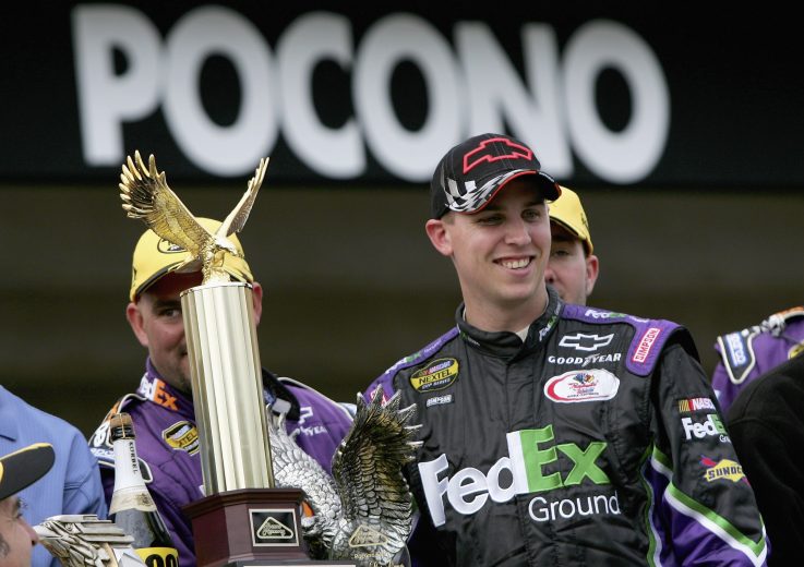 LONG POND, PA - JUNE 11: Denny Hamlin, driver of the #11 FedEx Ground Chevrolet, poses with the trophy after winning the NASCAR Nextel Cup Series Pocono 500 at the Pocono Raceway on June 11, 2006 in Long Pond, Pennsylvania. (Photo by Doug Pensinger/Getty Images) | Getty Images