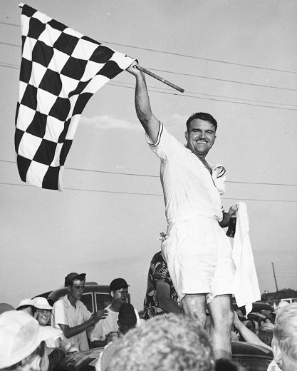 DARLINGTON, SC - SEPTEMBER 1, 1952: Fonty Flock, wearing Bermuda short pants and a short-sleeve shirt, won the 3rd annual Southern 500 at Darlington in 1952. He took the lead just before halfway in the race. (Photo by ISC Archives via Getty Images)