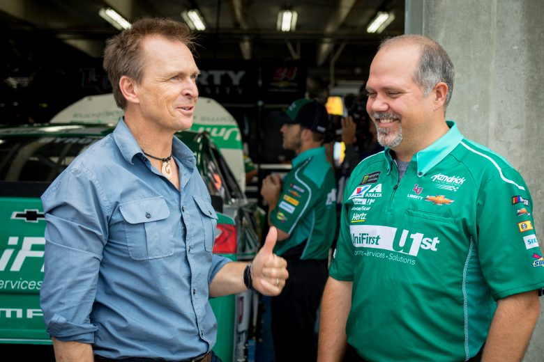 Concord, NC - (L to R) Host Phil Keoghan speaks to Hendrick Team crew chief Darian Grubb. (National Geographic/Alex Mandiola)