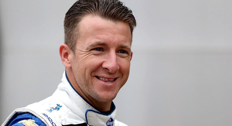 AJ Allmendinger looks on with a smile.
