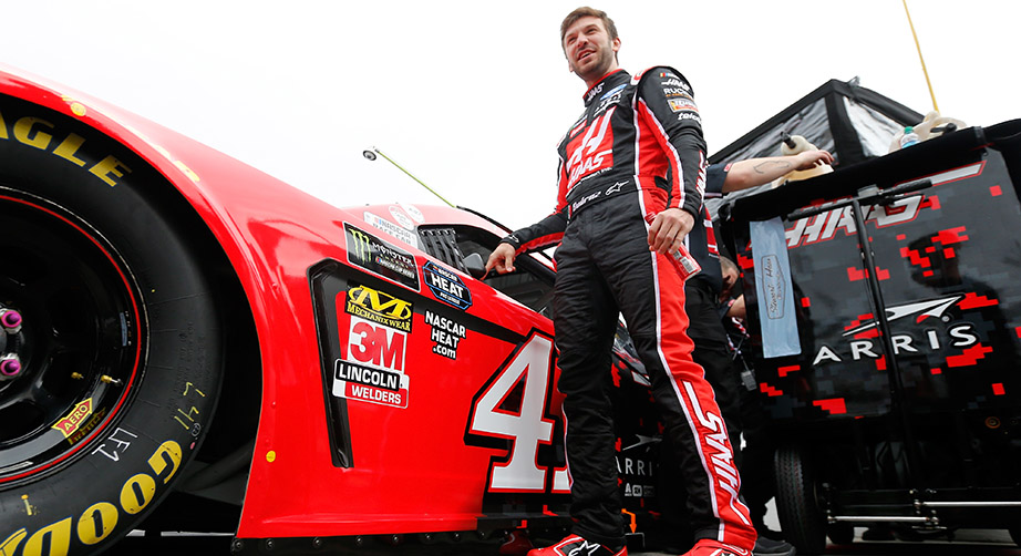 Daniel Suarez stands next to the No. 41 car at Daytona.