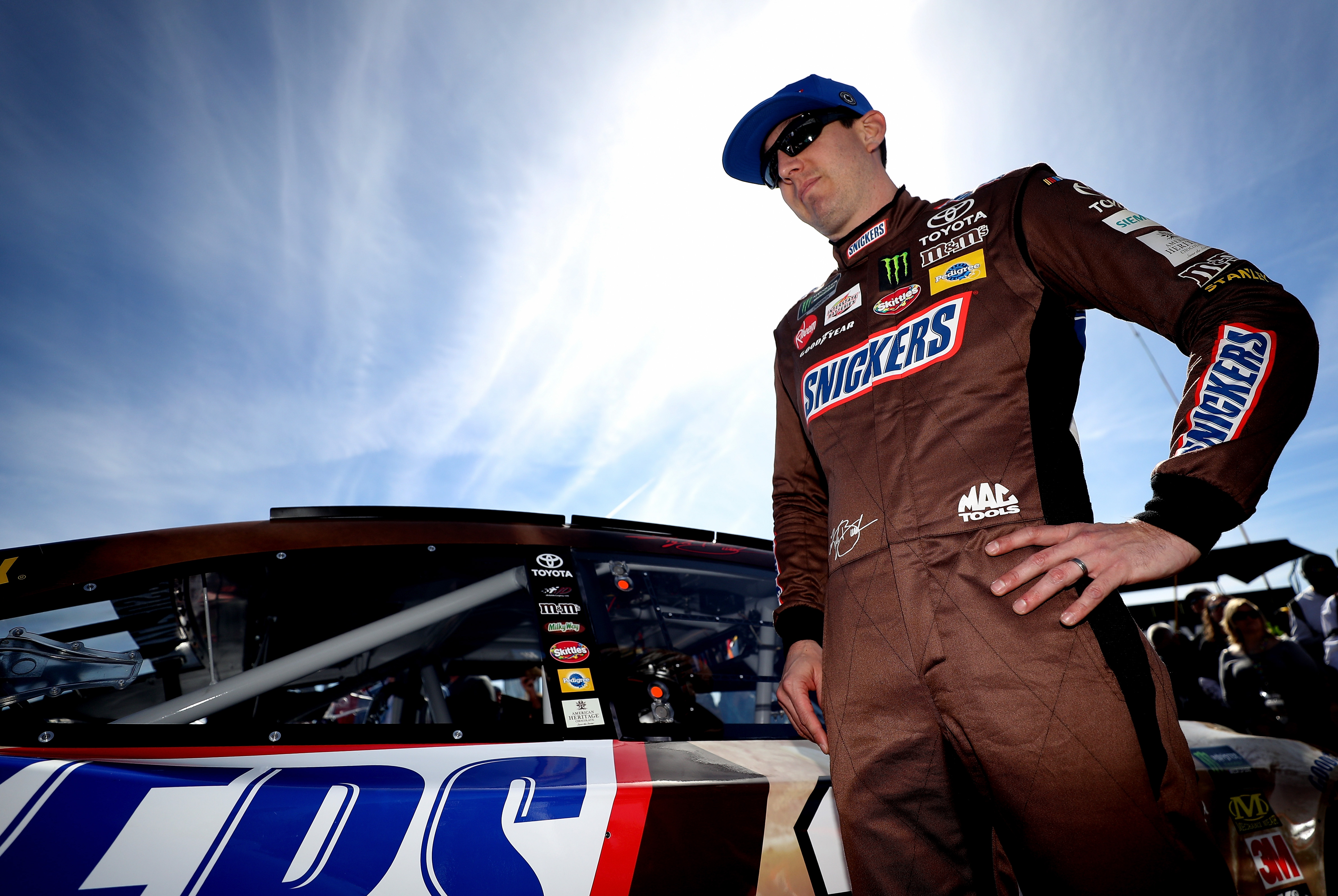 Kyle Busch stands next to his car at Atlanta.