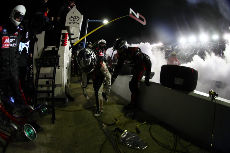 Natalie Decker jumps the pit road wall after getting out of her fiery truck.