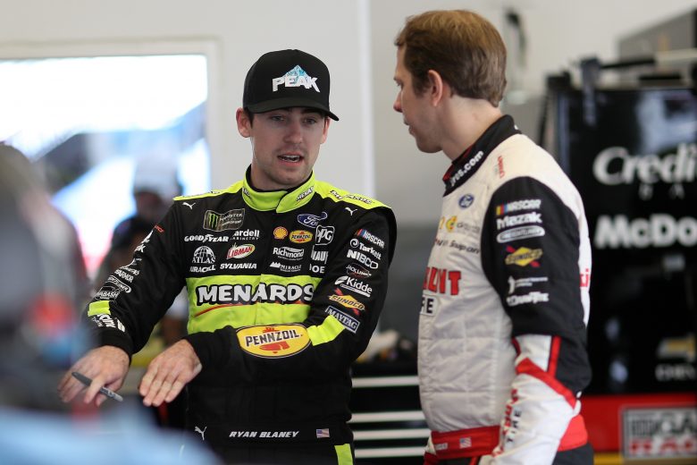 Ryan Blaney and Brad Keselowski talk in the garage during practice at Daytona.