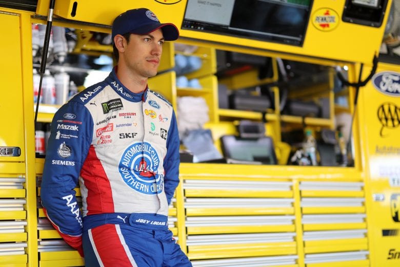 FONTANA, CA - MARCH 16:  Joey Logano, driver of the #22 AAA Southern California Ford, stands in the garage area during practice for the Monster Energy NASCAR Cup Series Auto Club 400 at Auto Club Speedway on March 16, 2019 in Fontana, California.  (Photo by Chris Graythen/Getty Images) | Getty Images