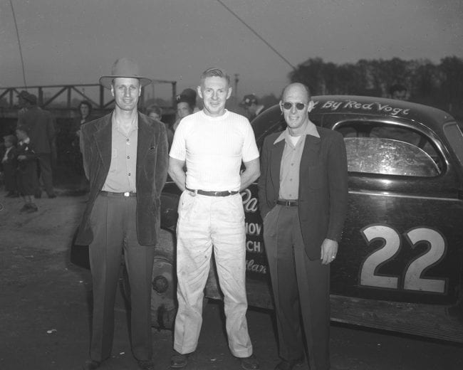 1949:  Car owner Raymond Parks (L), mechanic Red Vogt (C), and driver Red Byron (R) with their modified stock car. They won the very first NASCAR Modified national championship in 1948, then the very first NASCAR Strictly Stock (Cup division) championship in Õ49. (Photo by ISC Images & Archives via Getty Images)
