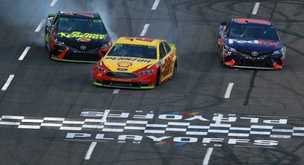 MARTINSVILLE, VA - OCTOBER 28: Joey Logano, driver of the #22 Shell Pennzoil Ford, takes the checkered flag ahead of Denny Hamlin, driver of the #11 FedEx Freight Toyota, and Martin Truex Jr., driver of the #78 5-hour ENERGY/Bass Pro Shops Toyota, to win the Monster Energy NASCAR Cup Series First Data 500 at Martinsville Speedway on October 28, 2018 in Martinsville, Virginia. (Photo by Sean Gardner/Getty Images) | Getty Images