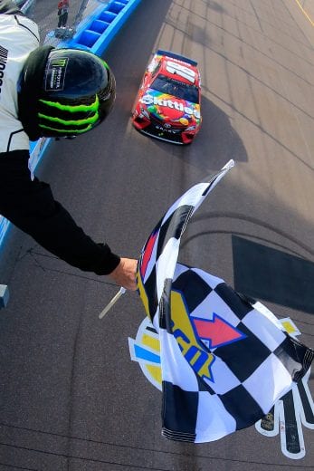 AVONDALE, AZ - MARCH 10:  Kyle Busch, driver of the #18 Skittles Toyota, takes the checkered flag to win the Monster Energy NASCAR Cup Series TicketGuardian 500 at ISM Raceway on March 10, 2019 in Avondale, Arizona.  (Photo by Daniel Shirey/Getty Images) | Getty Images