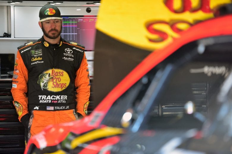 FONTANA, CA - MARCH 15: Martin Truex Jr., driver of the #19 Bass Pro Shops Toyota, stands in the garage area during practice for the Monster Energy NASCAR Cup Series Auto Club 400 at Auto Club Speedway on March 15, 2019 in Fontana, California. (Photo by Jared C. Tilton/Getty Images) | Getty Images