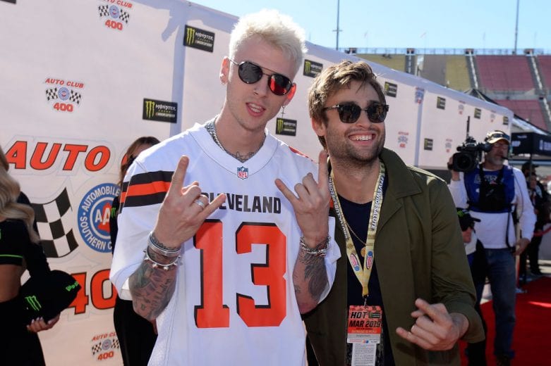 FONTANA, CA - MARCH 17: Machine Gun Kelly and Douglas Booth attend the driver's meeting prior to the Monster Energy NASCAR Cup Series Auto Club 400 at Auto Club Speedway on March 17, 2019 in Fontana, California. (Photo by Robert Laberge/Getty Images) | Getty Images