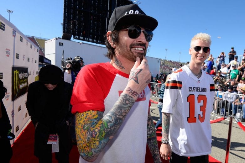 FONTANA, CA - MARCH 17: Tommy Lee and Machine Gun Kelly attend the driver's meeting prior to the Monster Energy NASCAR Cup Series Auto Club 400 at Auto Club Speedway on March 17, 2019 in Fontana, California. (Photo by Robert Laberge/Getty Images) | Getty Images