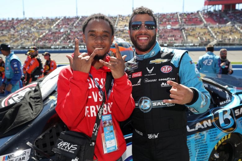 FONTANA, CA - MARCH 17: Slim Jxmmi talks with Bubba Wallace, driver of the #43 PlanBSales.com Chevrolet, prior to the Monster Energy NASCAR Cup Series Auto Club 400 at Auto Club Speedway on March 17, 2019 in Fontana, California. (Photo by Chris Graythen/Getty Images) | Getty Images
