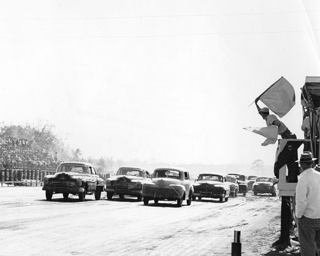 MOBILE, AL — April 8, 1951:  Red Harrelson of Pensacola, FL, starts from the pole position in a 1947 Ford as the field takes the green flag for the start of a NASCAR Cup race at New Mobile Speedway.  Harrelson faded to a 23rd place finish, while outside pole sitter Tim Flock drove Ted Chester’s “Black Phantom” Oldsmobile to the race victory.  (Photo by ISC Images & Archives via Getty Images)