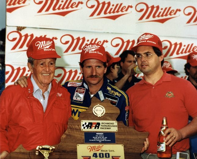 RICHMOND, VA — March 8, 1987: Track owner Paul Sawyer (L) joins Dale Earnhardt (C) in victory lane at Richmond International Raceway after Earnhardt won the Miller High Life 400 NASCAR Cup race. (Photo by ISC Images & Archives via Getty Images)