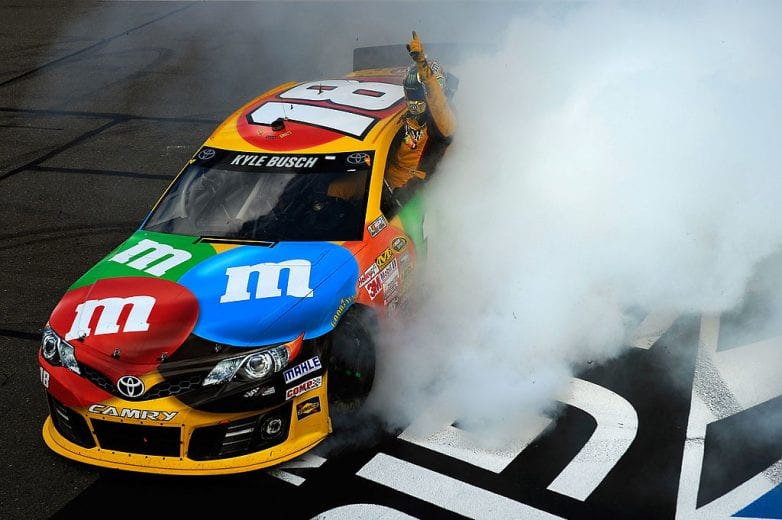 WATKINS GLEN, NY - AUGUST 11: Kyle Busch, driver of the #18 M&M's Toyota, celebrates with a burnout after winning the NASCAR Sprint Cup Series Cheez-It 355 at The Glen at Watkins Glen International on August 11, 2013 in Watkins Glen, New York. (Photo by Jared C. Tilton/NASCAR via Getty Images)