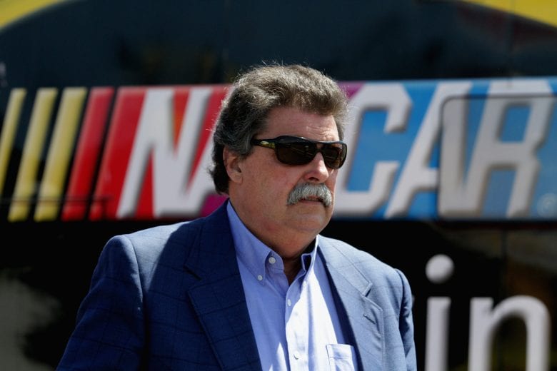 LONG POND, PA - JUNE 07:  NASCAR president Mike Helton walks through the garage area during practice for the NASCAR Sprint Cup Series Pocono 400 at Pocono Raceway on June 7, 2014 in Long Pond, Pennsylvania.  (Photo by Jerry Markland/Getty Images) | Getty Images
